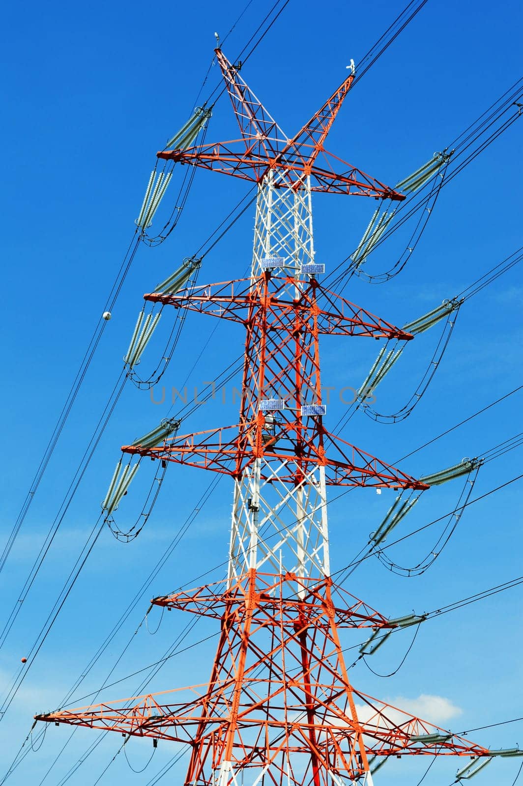 Power pylon over blue sky. Electrical transmission tower.