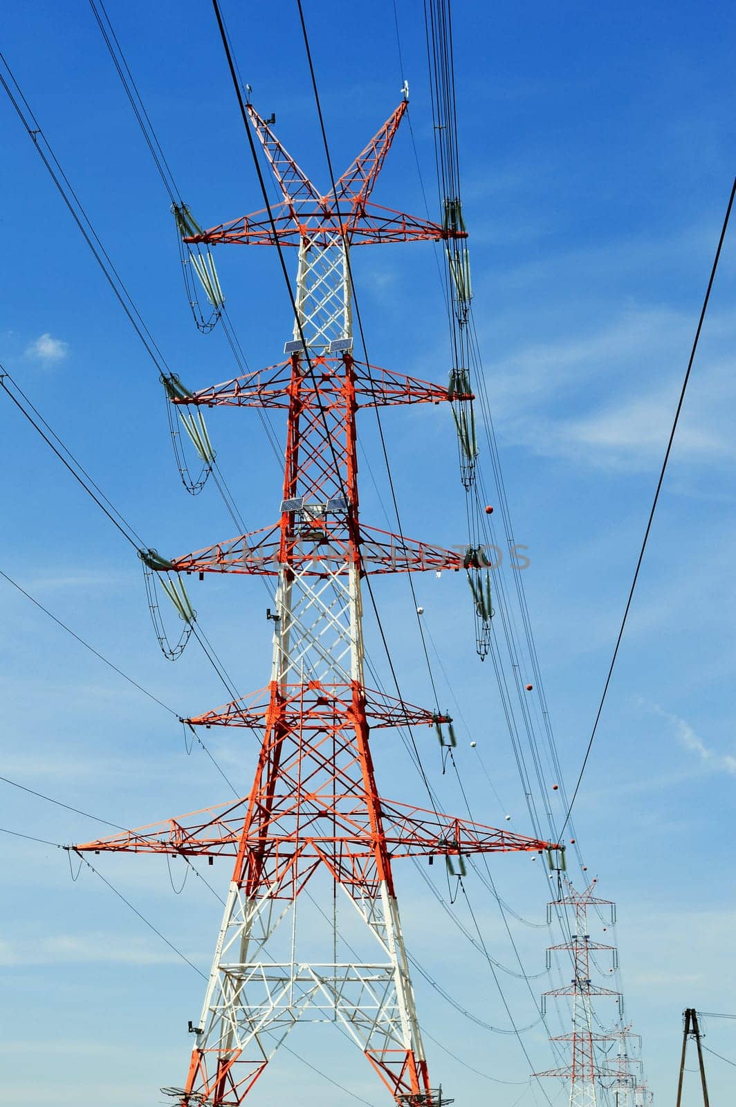 Power pylon over blue sky. Electrical transmission tower.
