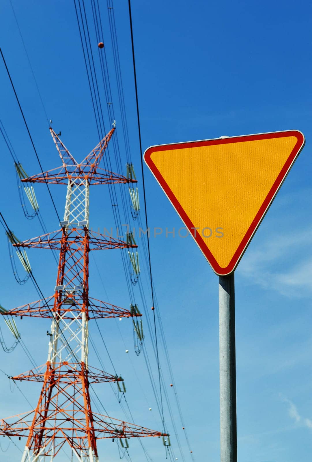 Power pylon over blue sky. Electrical transmission tower.