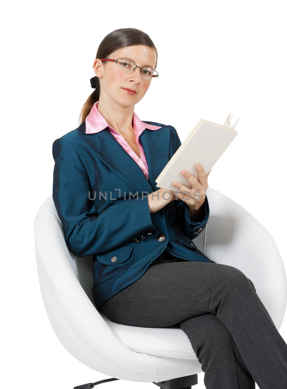 Young woman in glasses with a book and sitting in a chair