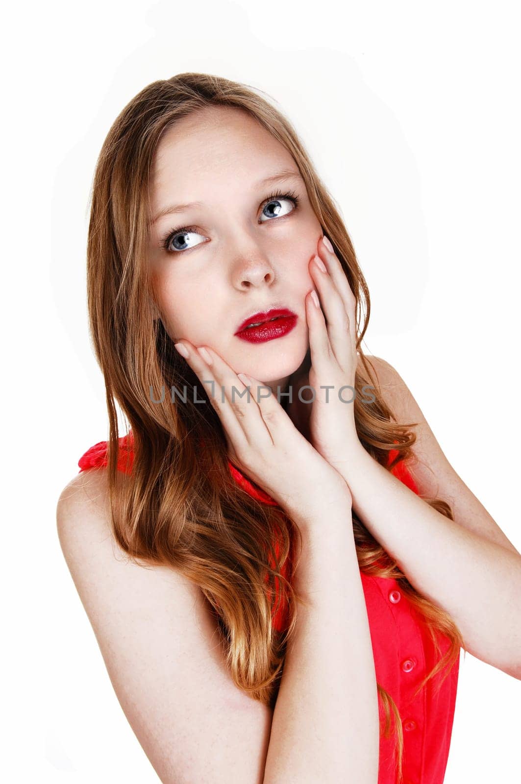 A young teen girl in a red blouse holding her hands on her face, .isolated for white background..
