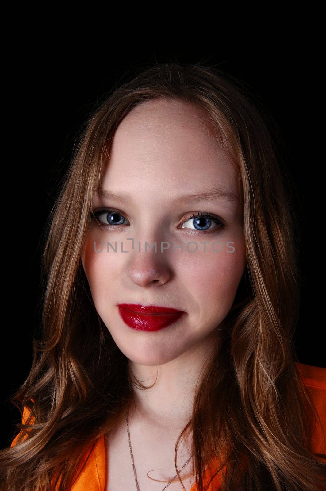 A closeup portrait picture of a lovely teenage girl with blue eye's, .isolated for black background..