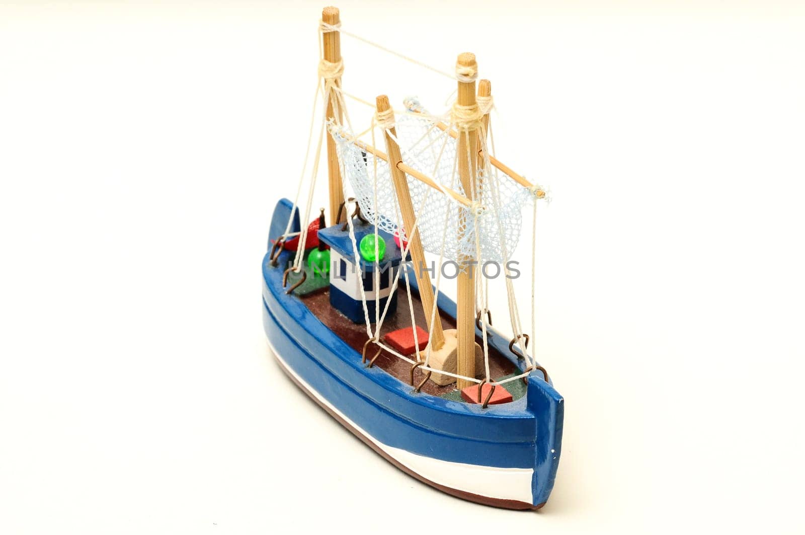 Beautiful miniature ship. Wooden sailship figurine. Antique model sailing boat isolated on white