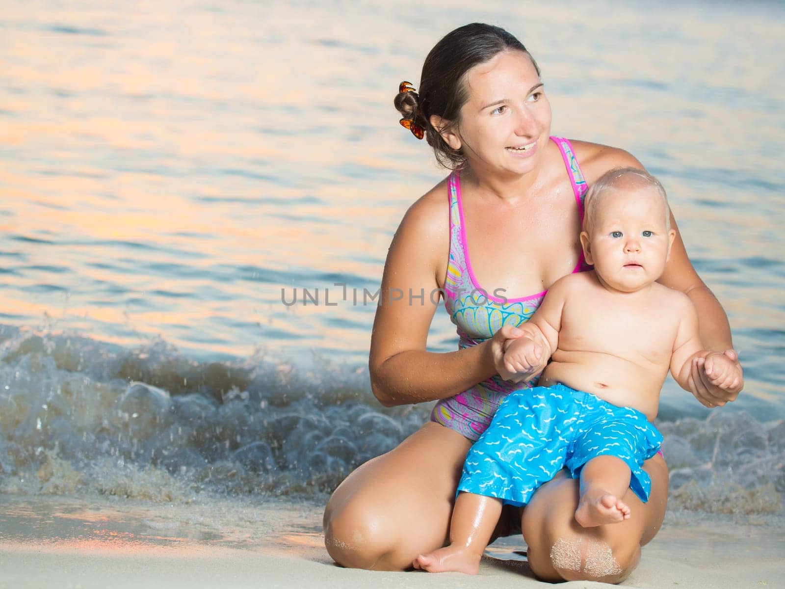 Baby and mother on the tropical beach