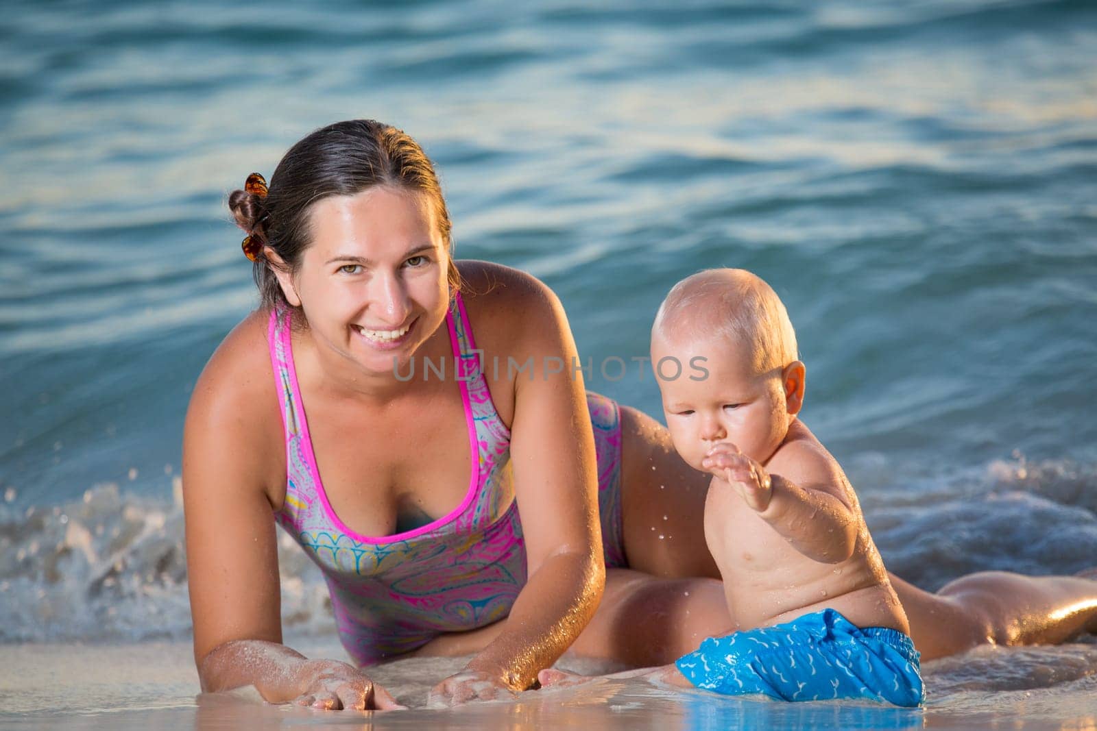 Baby and mother on the tropical beach