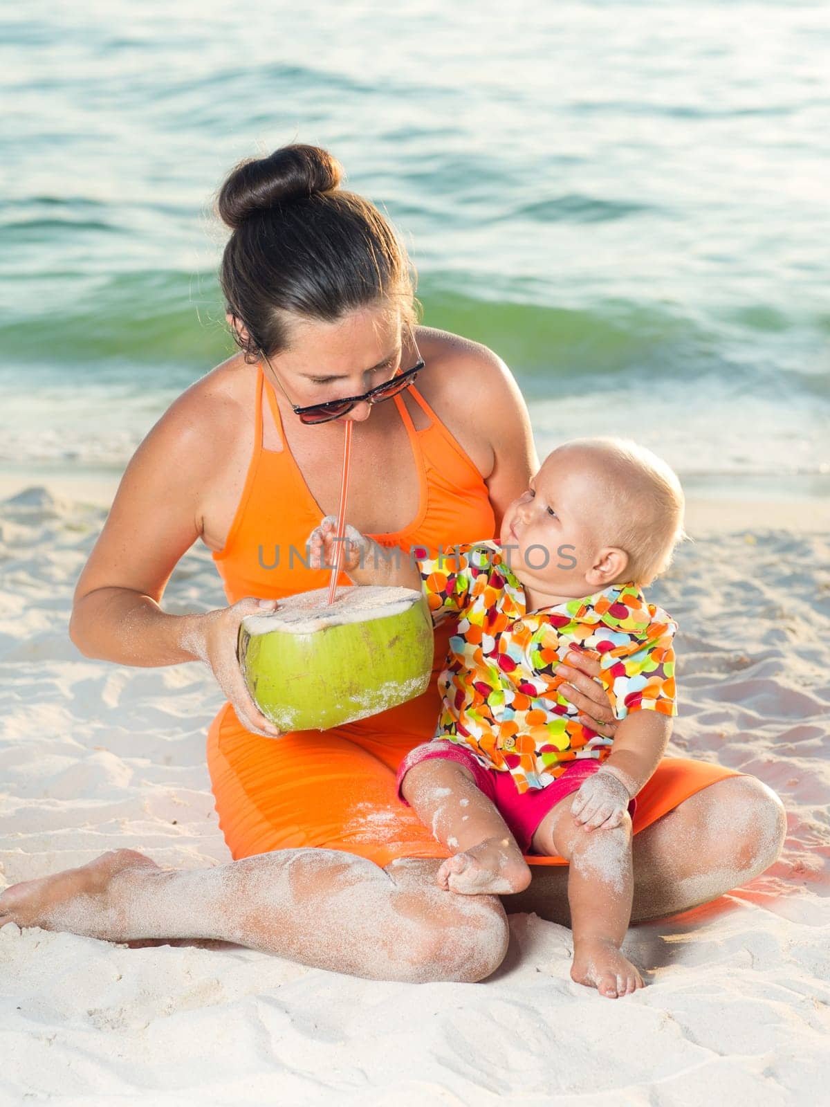 Baby and mother on the tropical beach