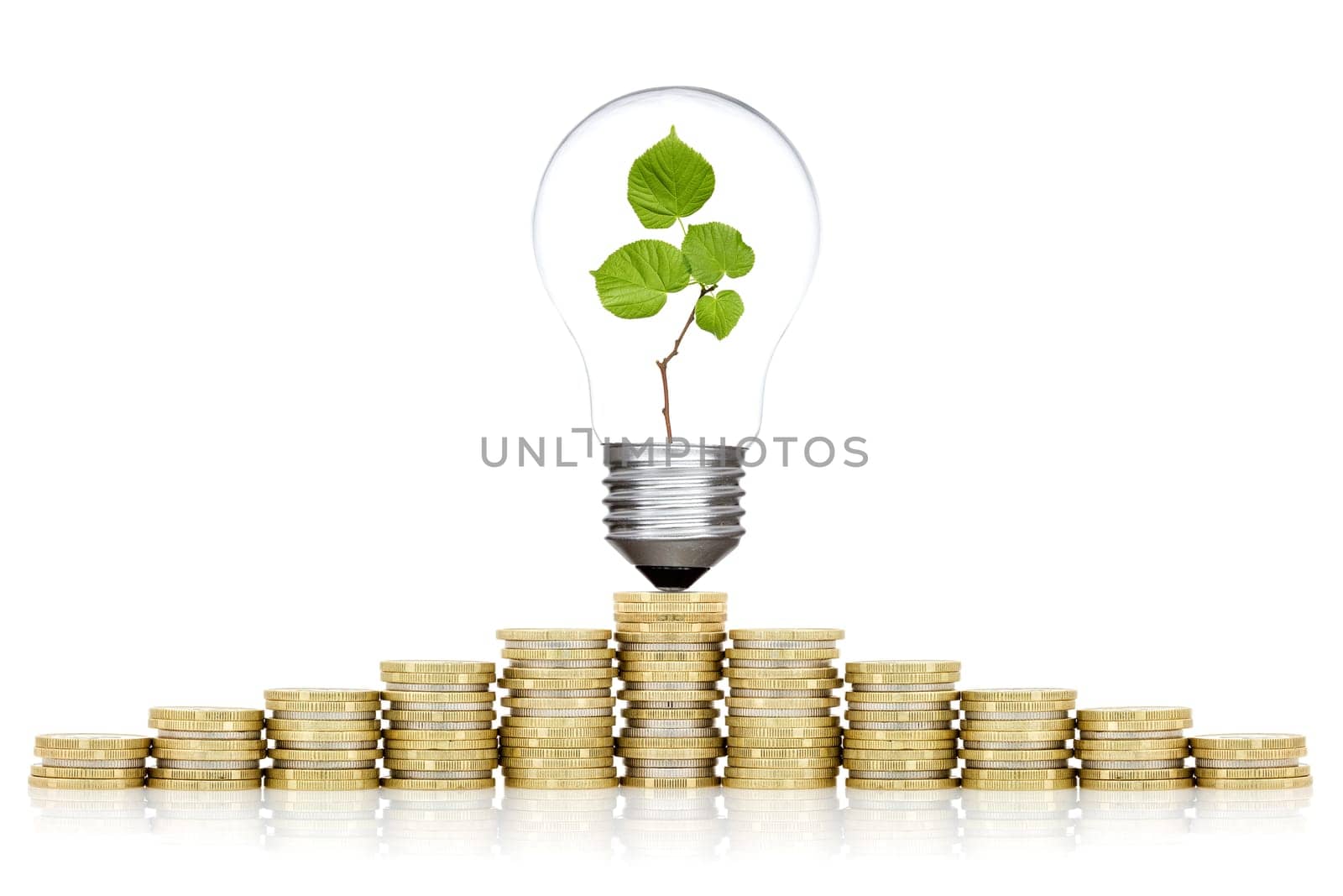 Saving money concept. Bulb and coins stacked on white background