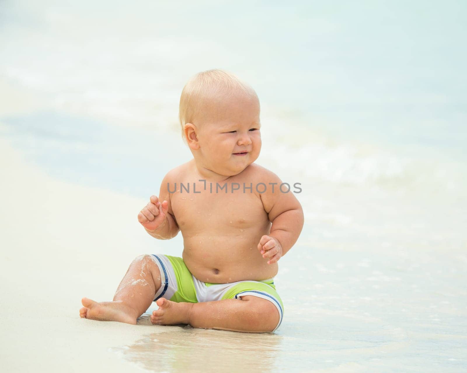Cute baby on the tropical beach