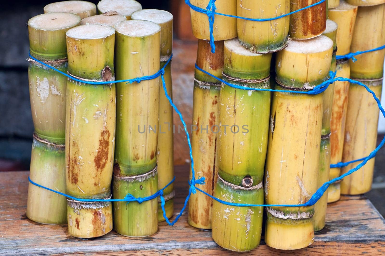 A close up photo of a stack of sugar cane sticks