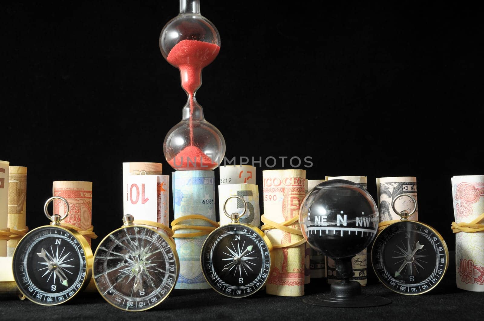 Business Time Concept Money and Hourglass on a Black Background