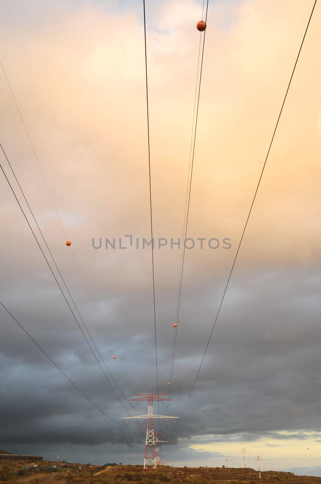 Power Electric Tower on a Cloudy Sky at Sunset