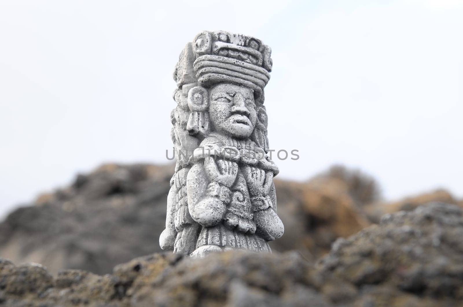Ancient Maya Statue on the Rocks near Ocean
