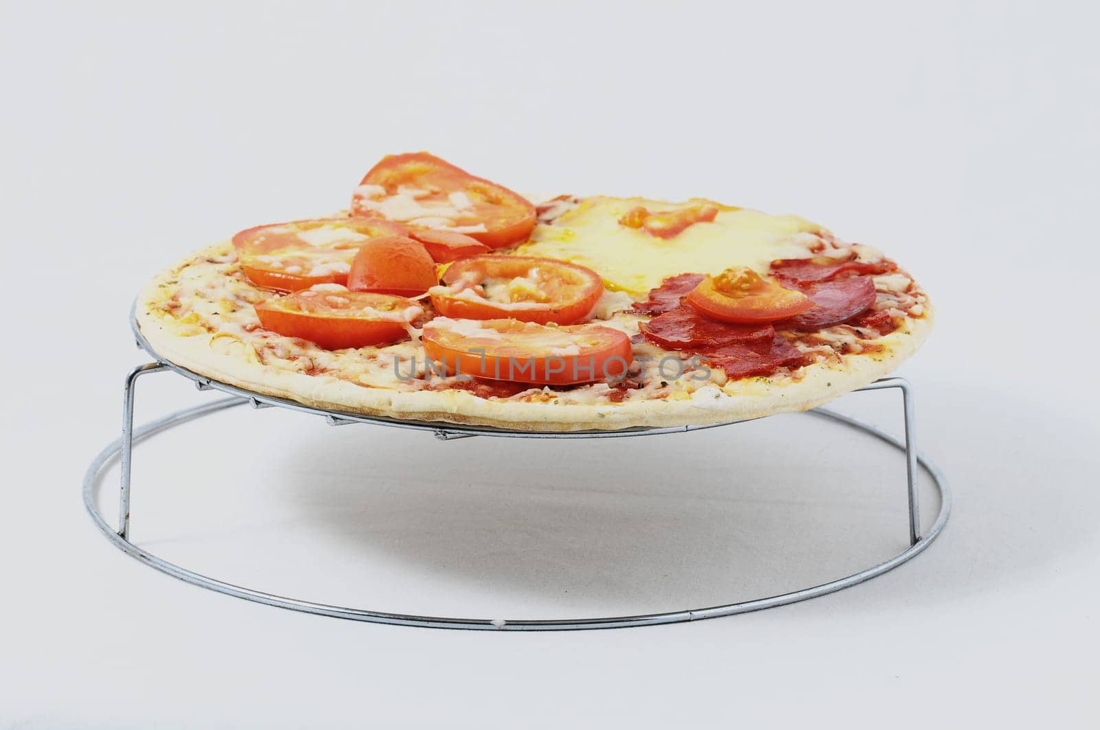 Cooked Mixed Italian Pizza over a White Background