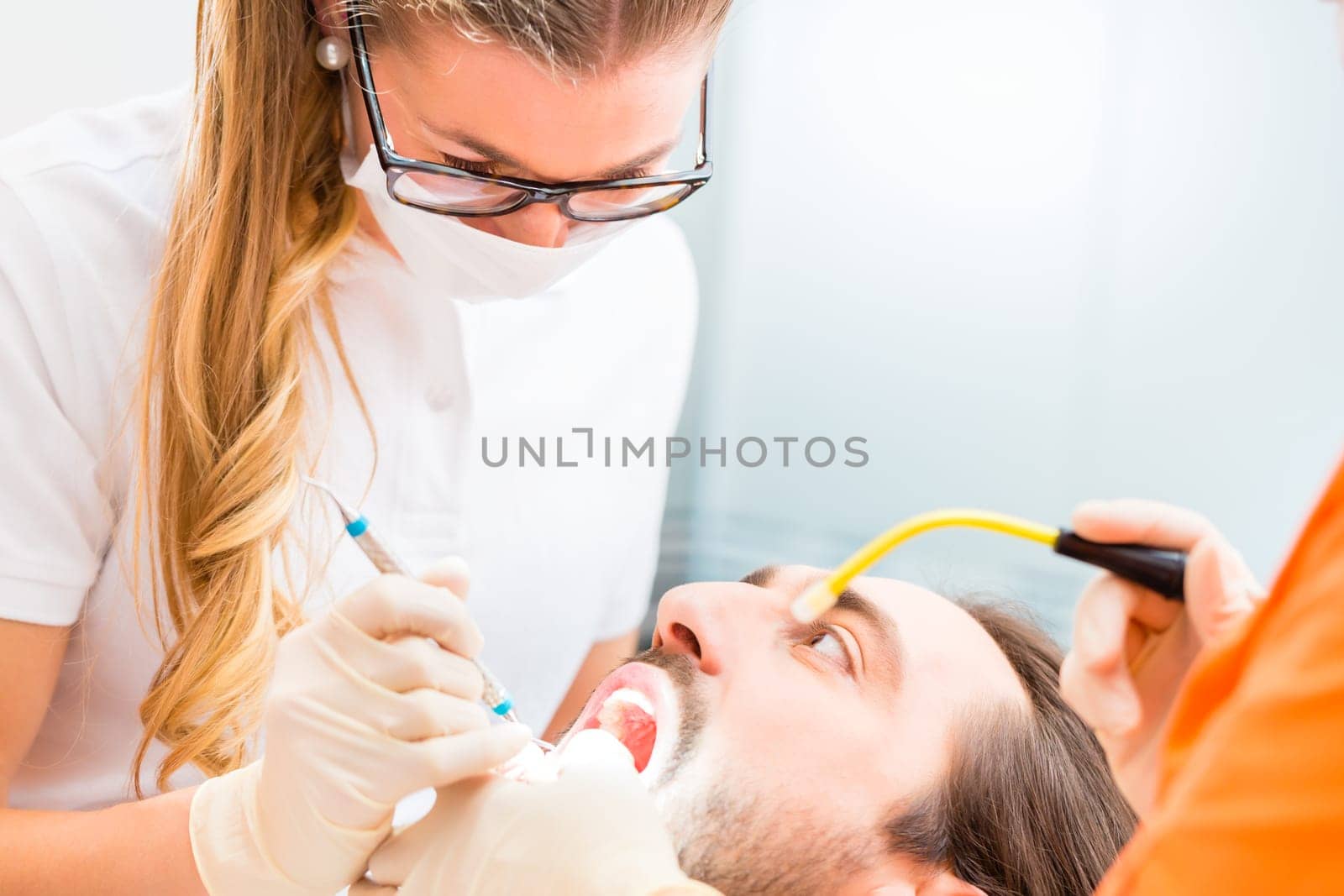 Patient having dental deep tooth cleaning at dentist
