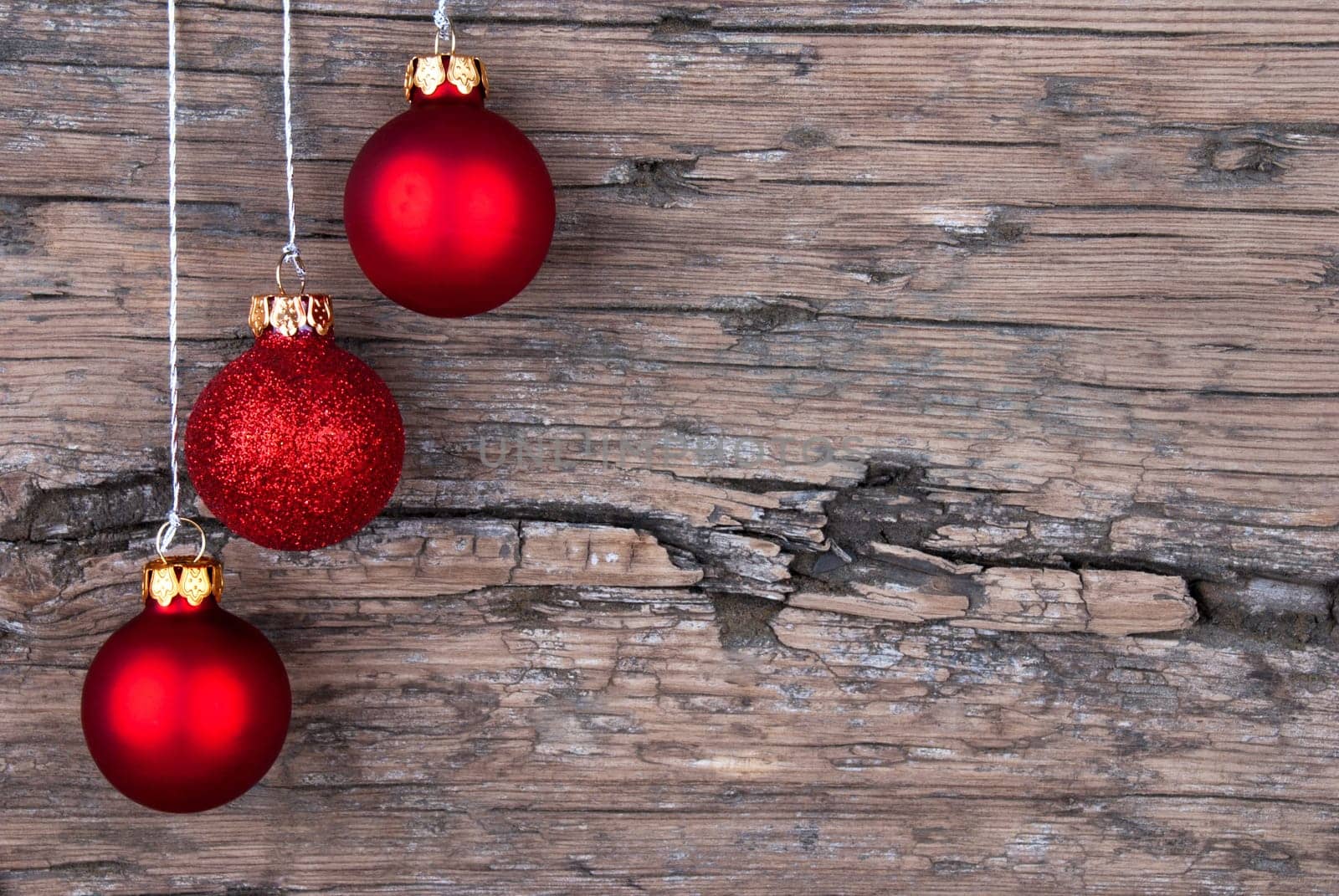 Three Red Christmas Tree Balls on Wood with Copy Space