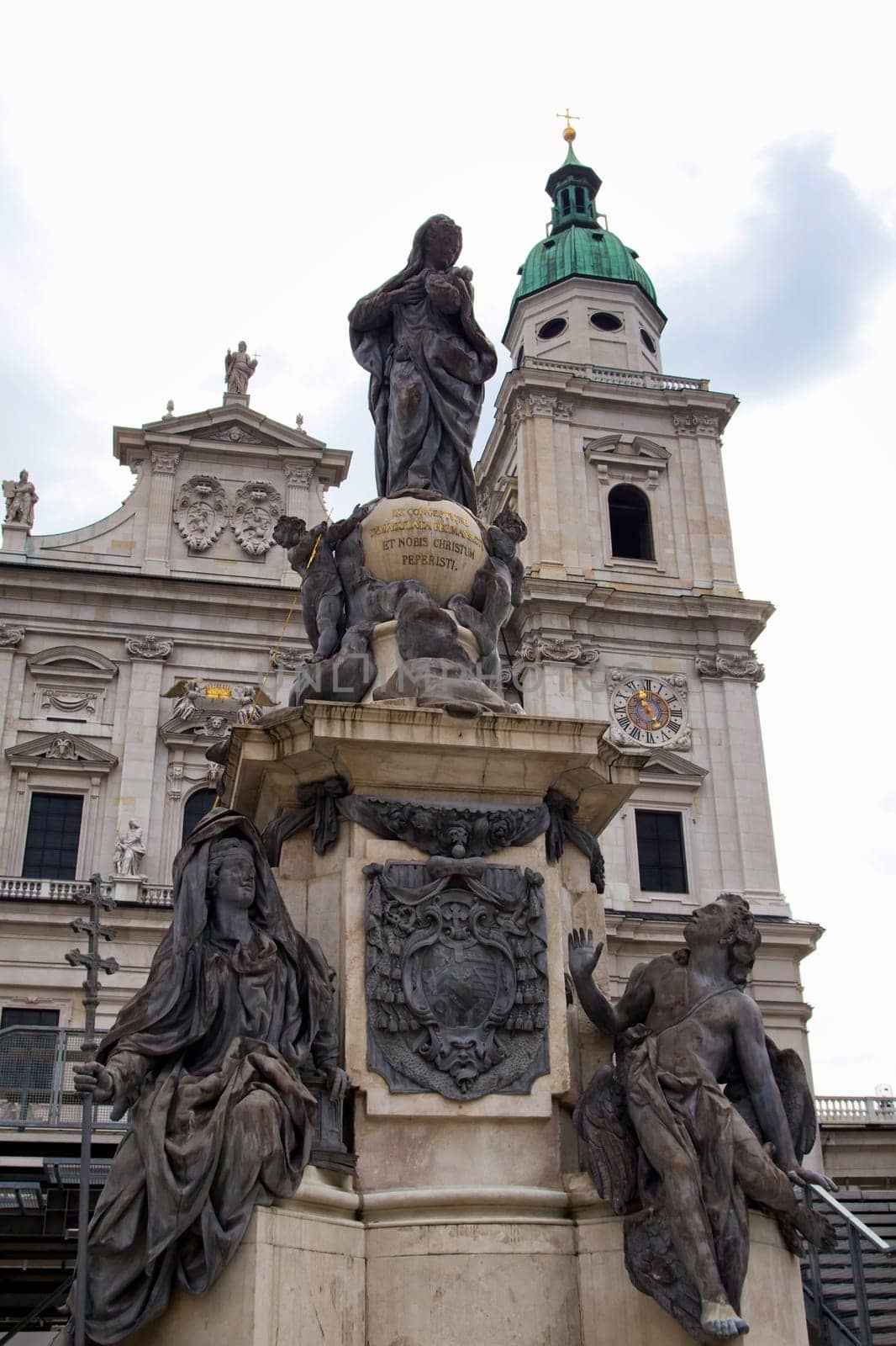 The facade of the Basilica of St. Peter in Salzburg (Austria). Marian column, whose peculiarity is the base of a marble and statue of the lead.