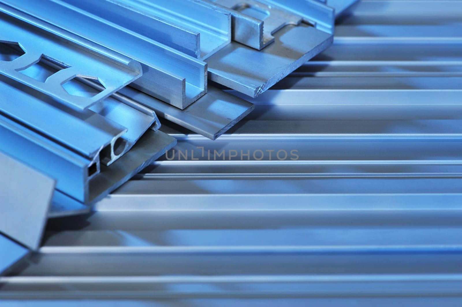 many different aluminium profile strips in blue light