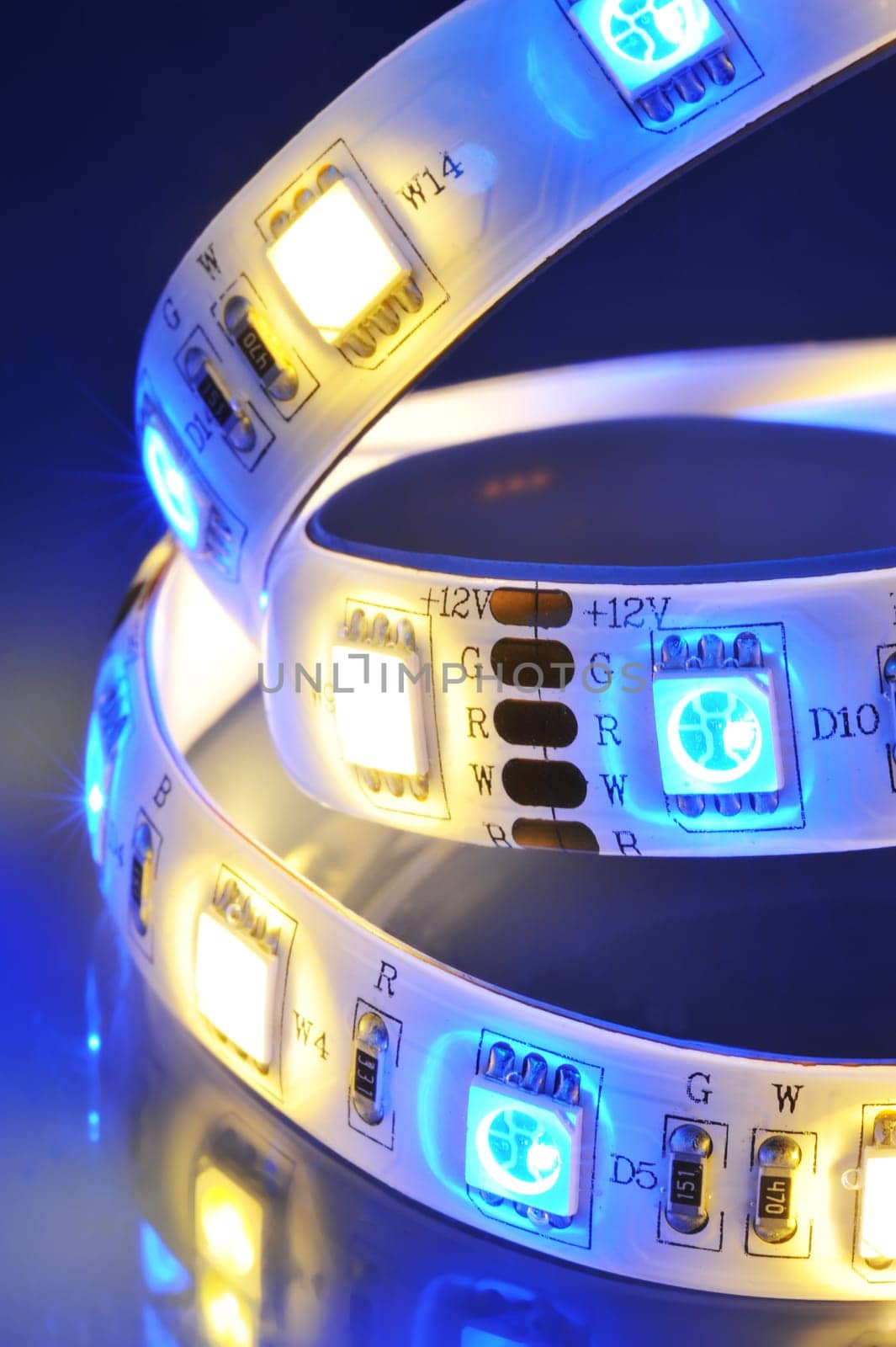 Macrodetail of an RGBW LED strip with warm white LEDs in colored light