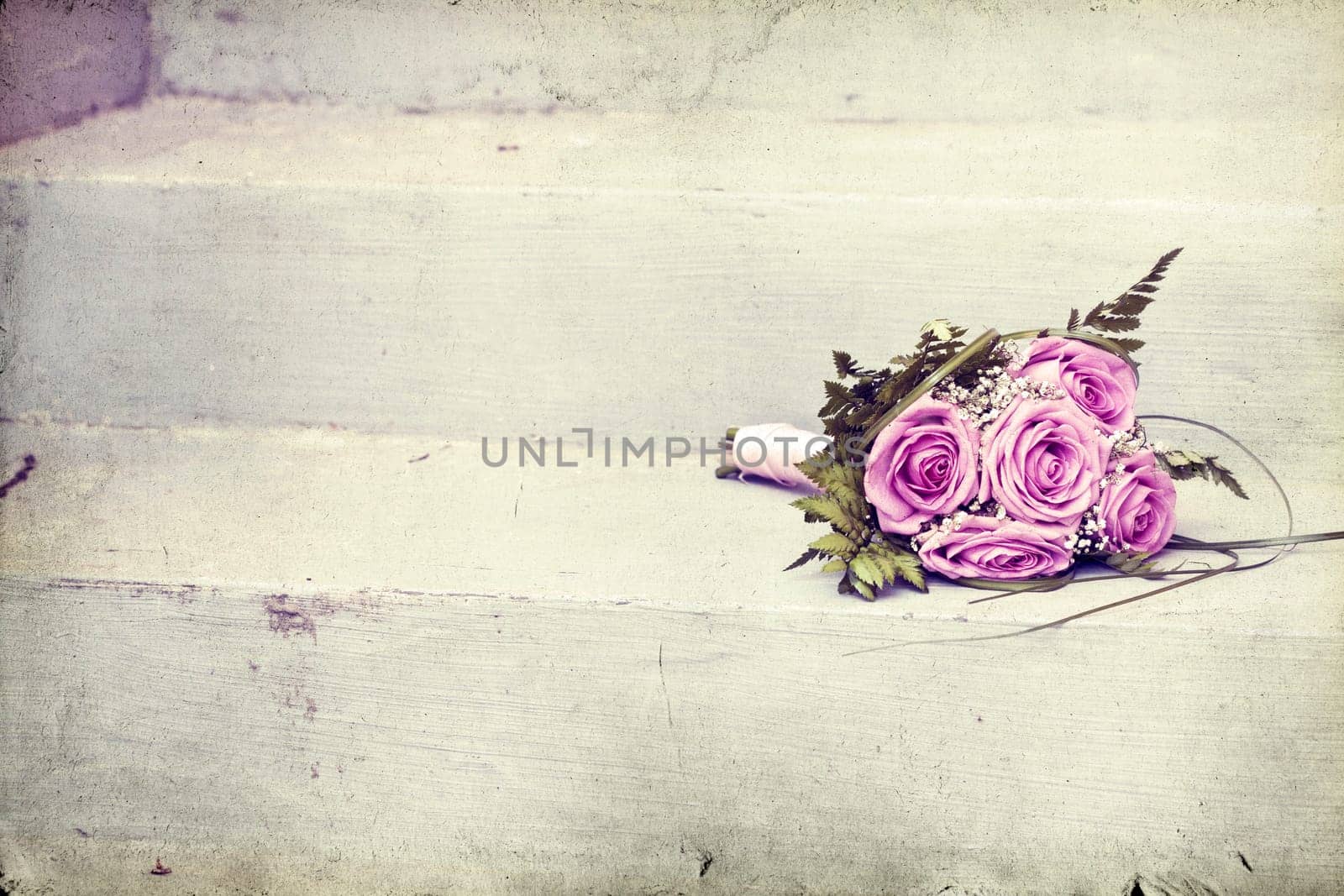 Vintage photo of pink wedding bouquet on the stairs