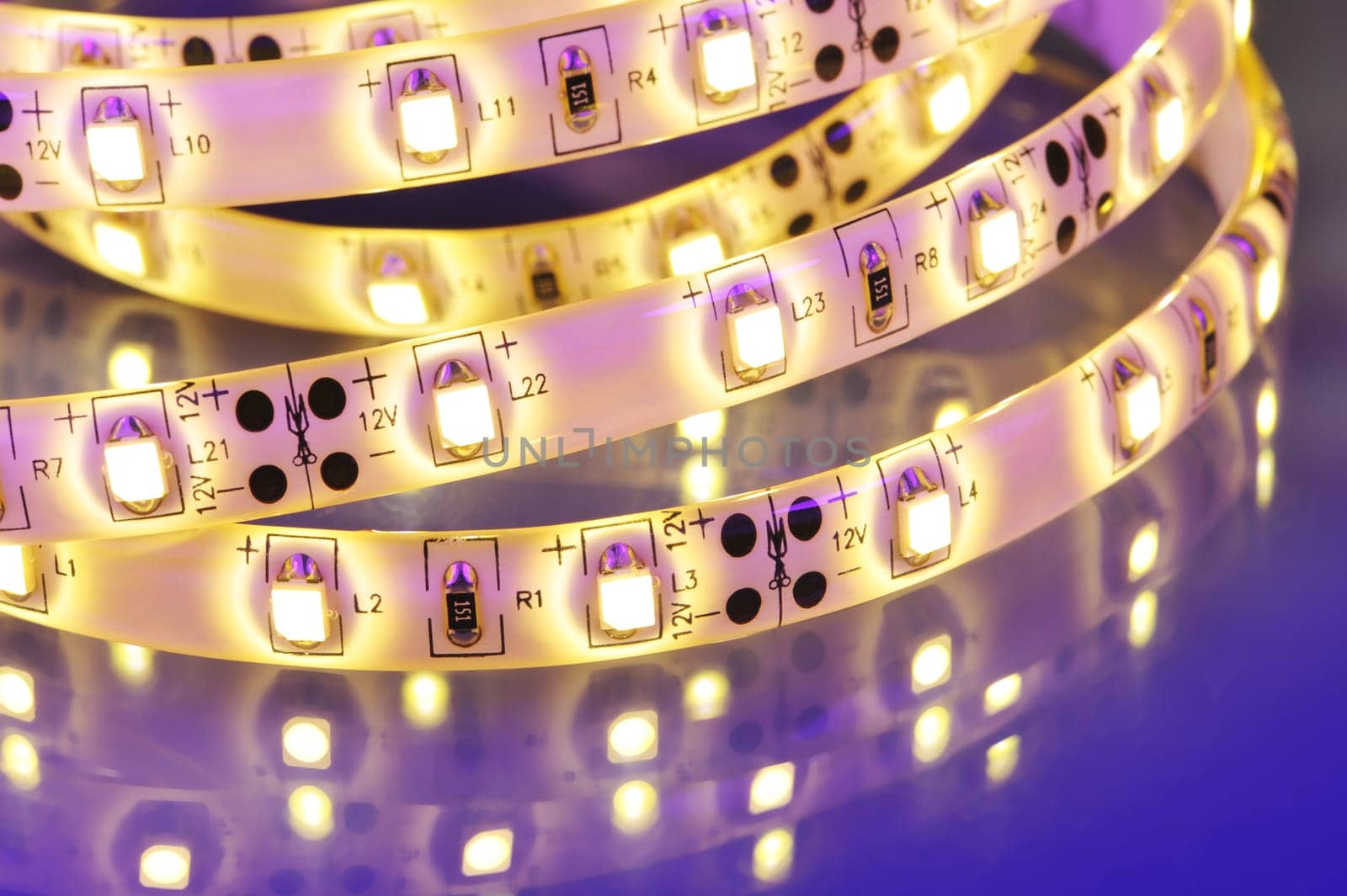 Macrodetail of a warm white LED strip in coloured light