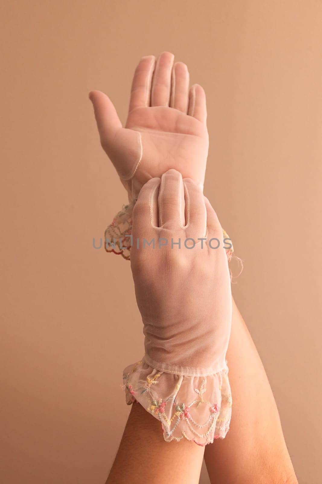 Image of woman's forearms and hands modeling vintage lace see through gloves.