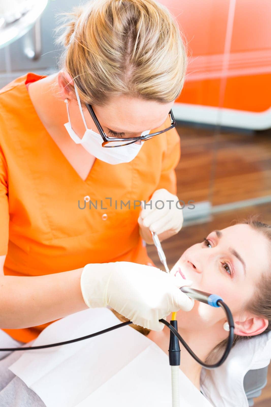 Patient having dental tooth cleaning at dentist