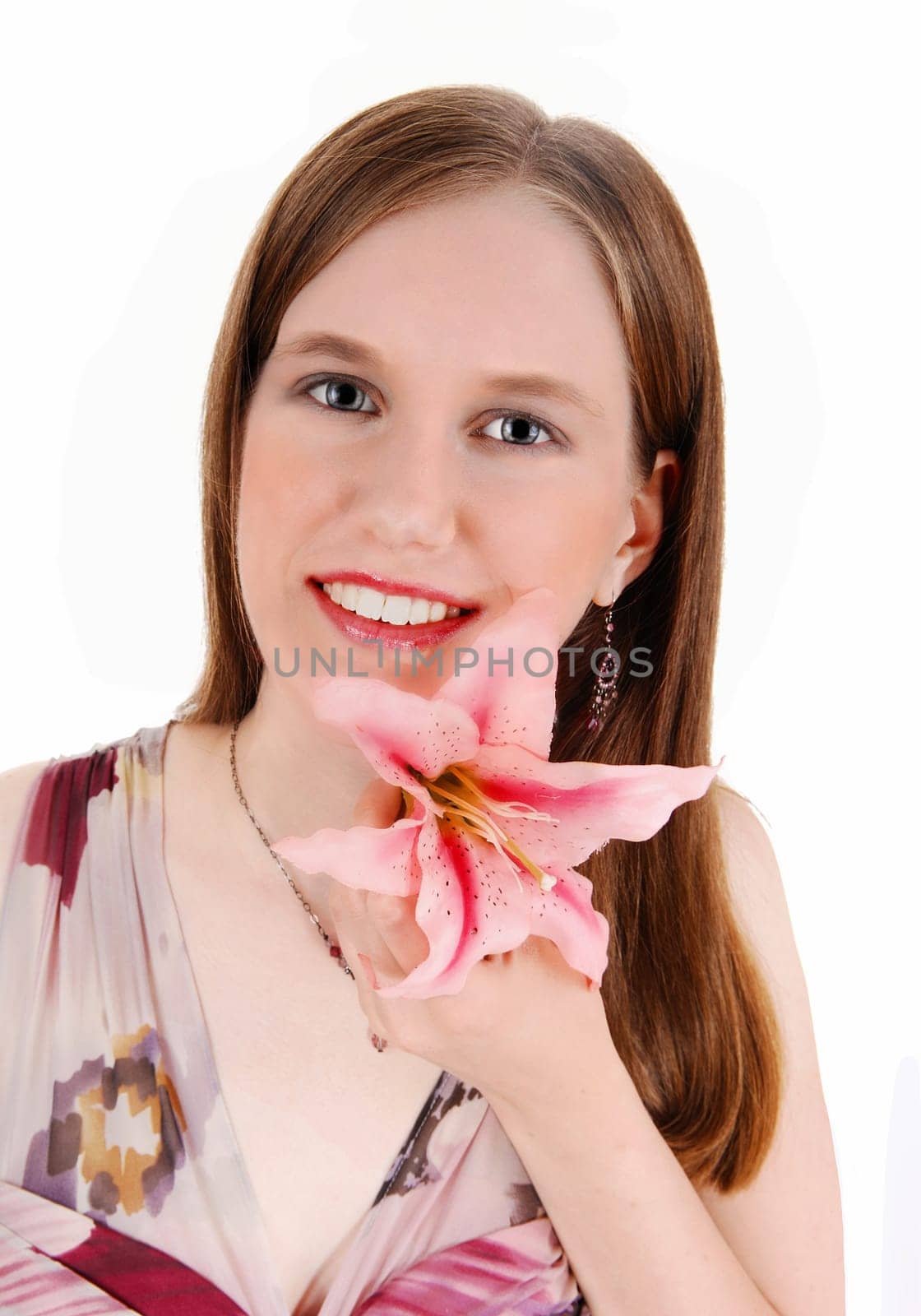 A young pretty woman in a portrait picture holding a pink lily in her hand,.smiling, isolated for white background..