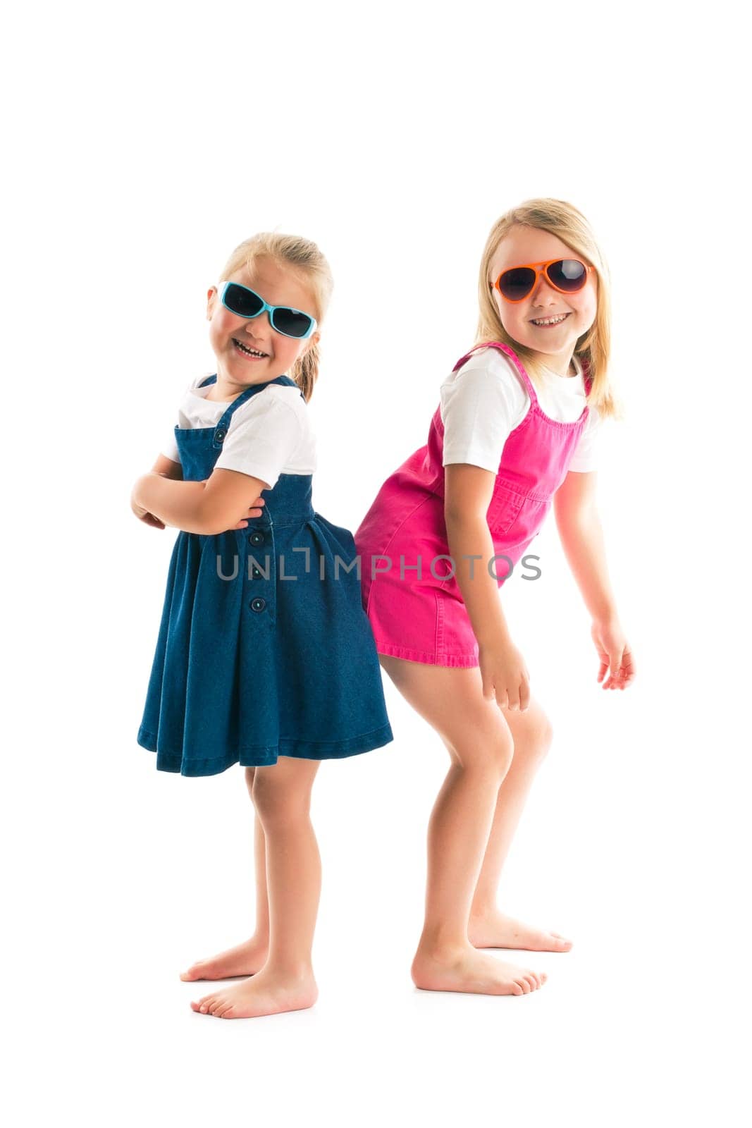 two happy little sisters isolated on white