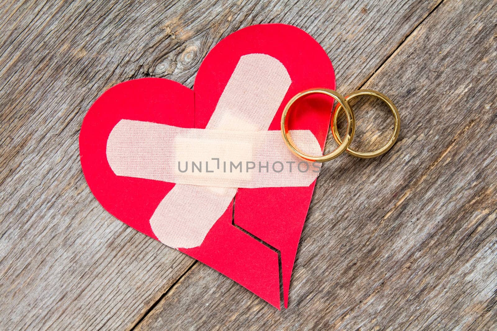 Wedding rings and heart fixed with plaster