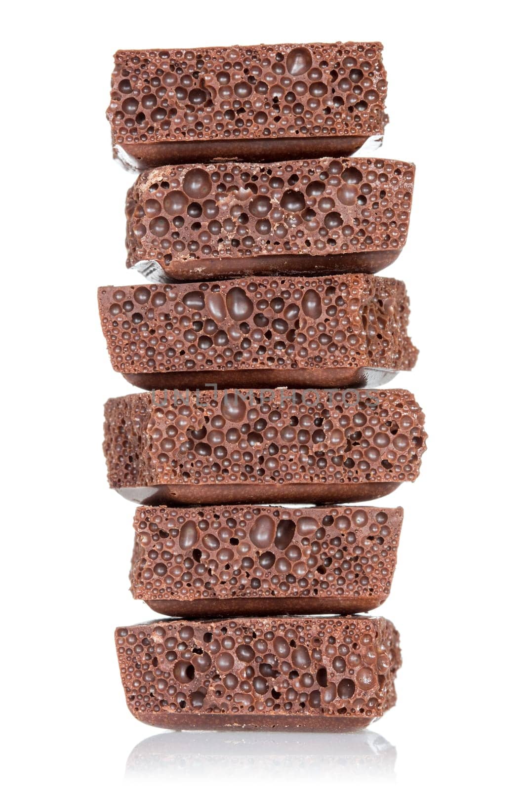 Stack of chocolate pieces on a white background