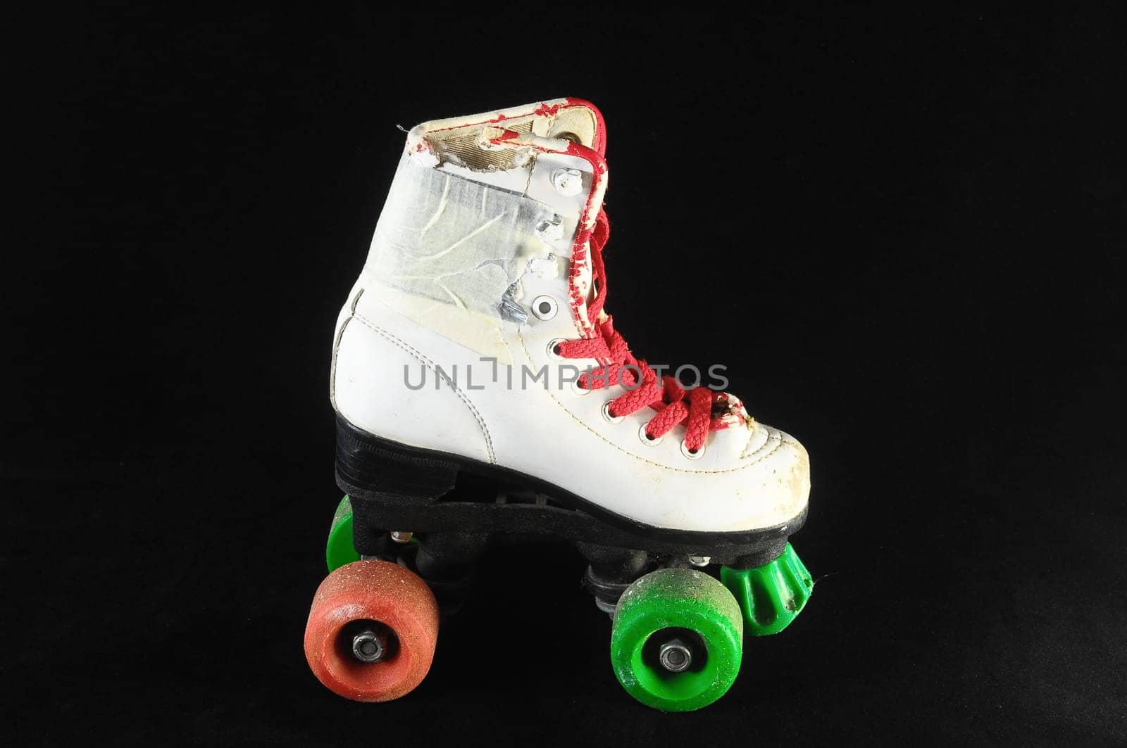 Used Vintage Consumed Roller Skate on a Black Background