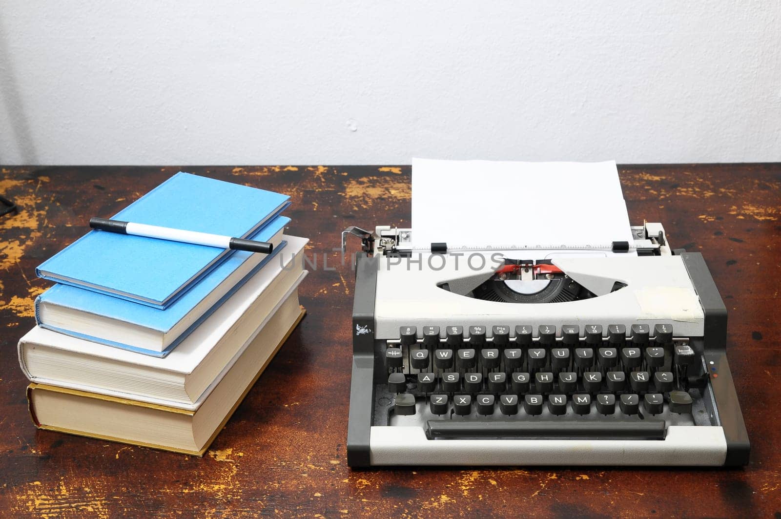 Old Vintage Travel Typewriter on a Brown Wooden Table