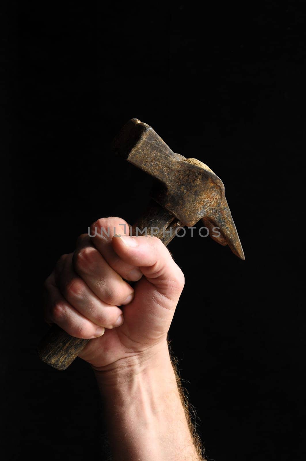 Hammer and a Hand on a Black Background