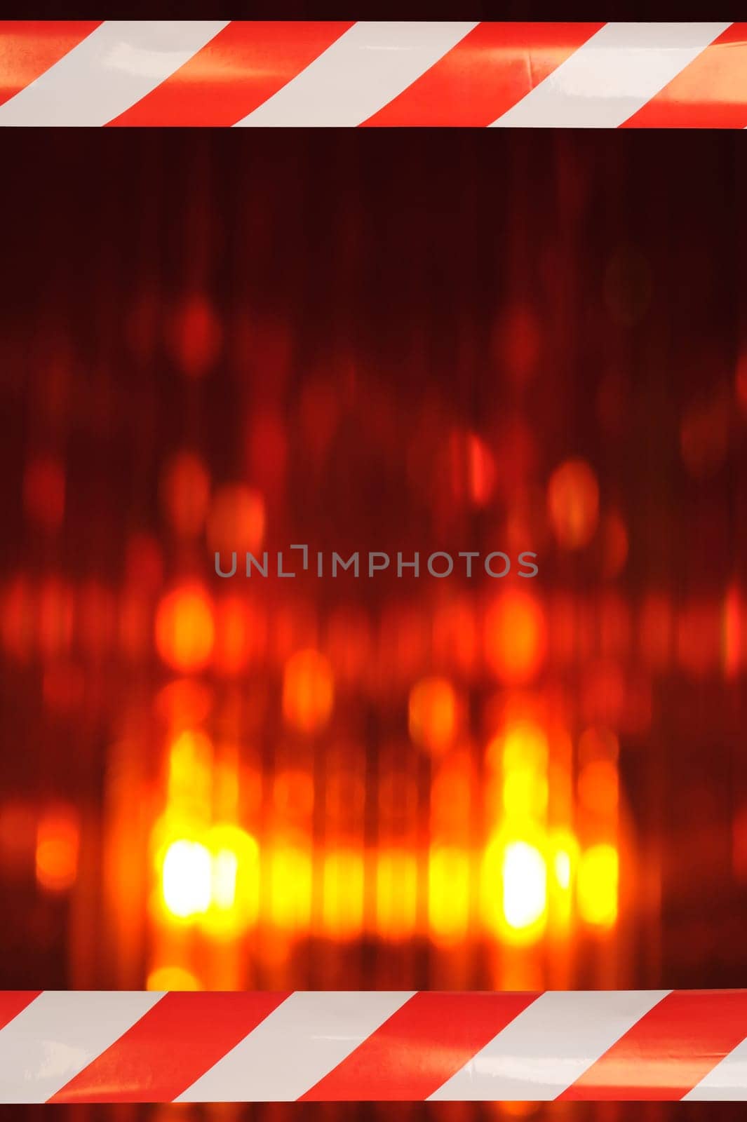 Construction site background with macro detail of an orange all-round light and two original shut-off strips