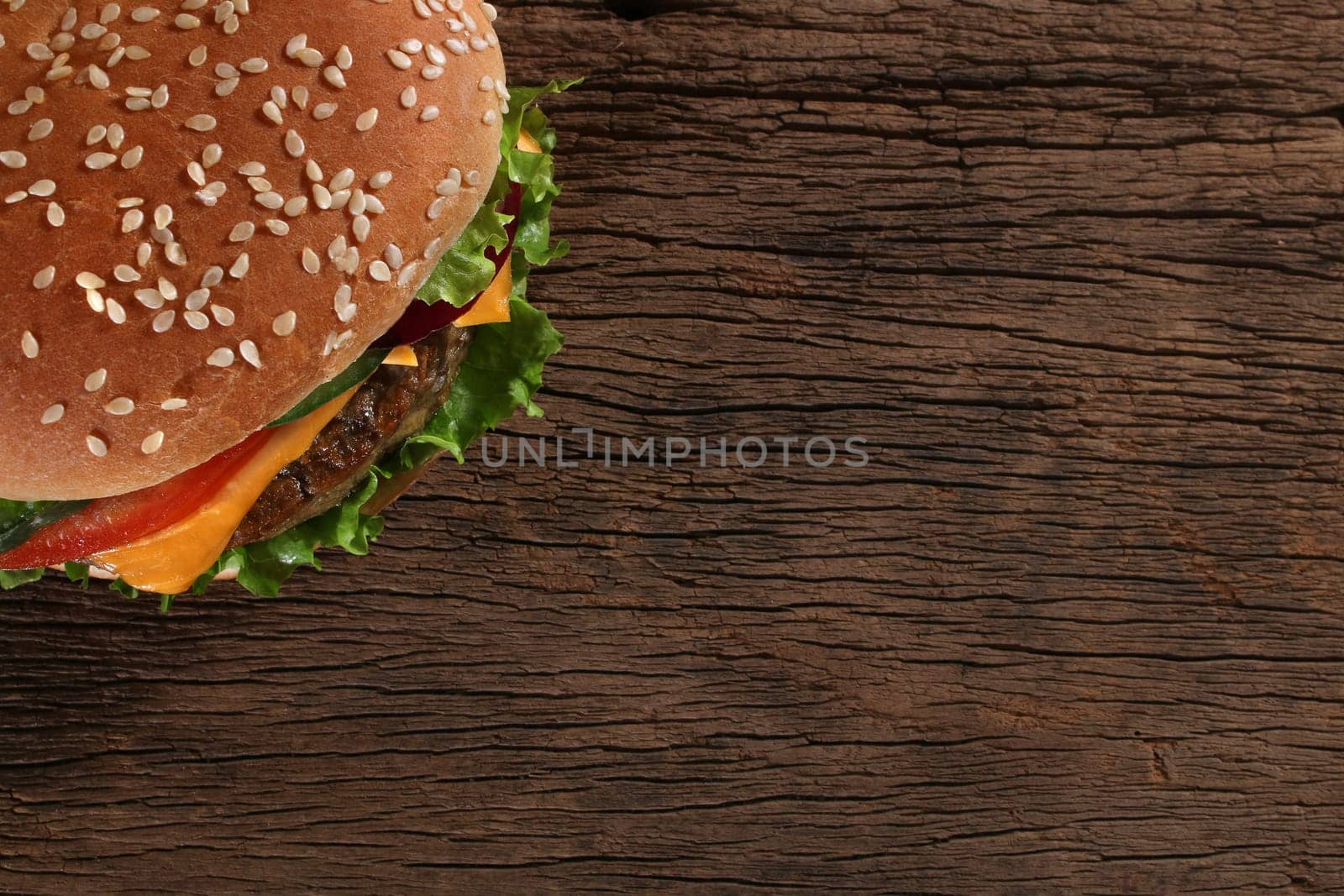 Tasty hamburger on wood background. Space for text