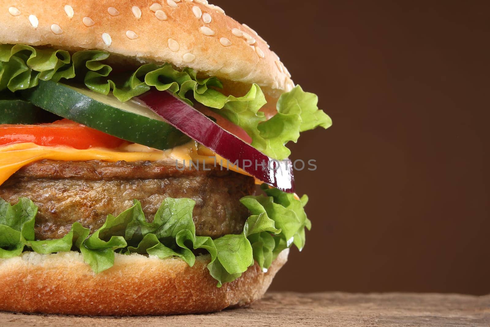 Tasty hamburger on wood background. Lots of ingredients