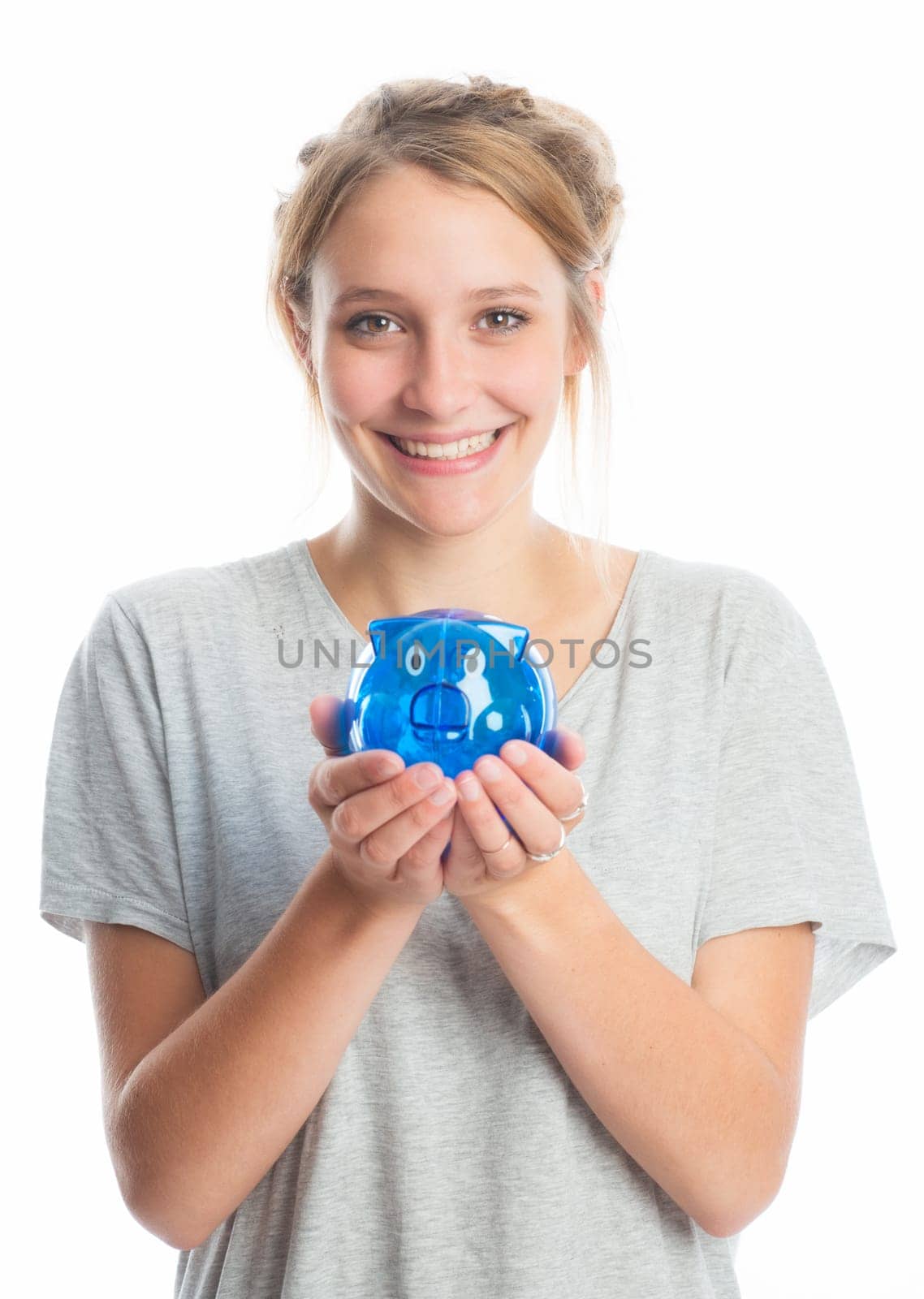 Blonde girl holds a piggy bank