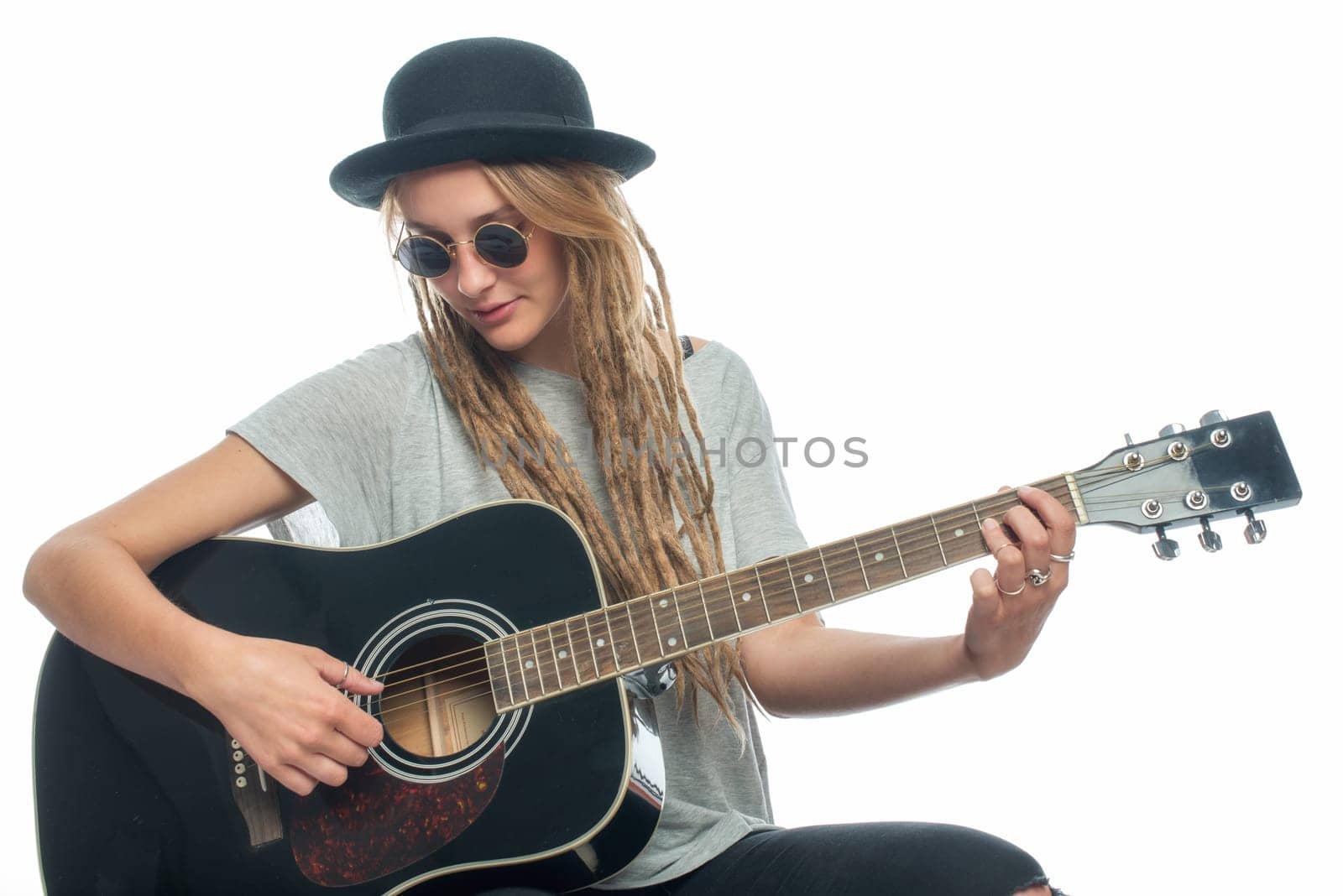 Blonde girl with hat and guitar