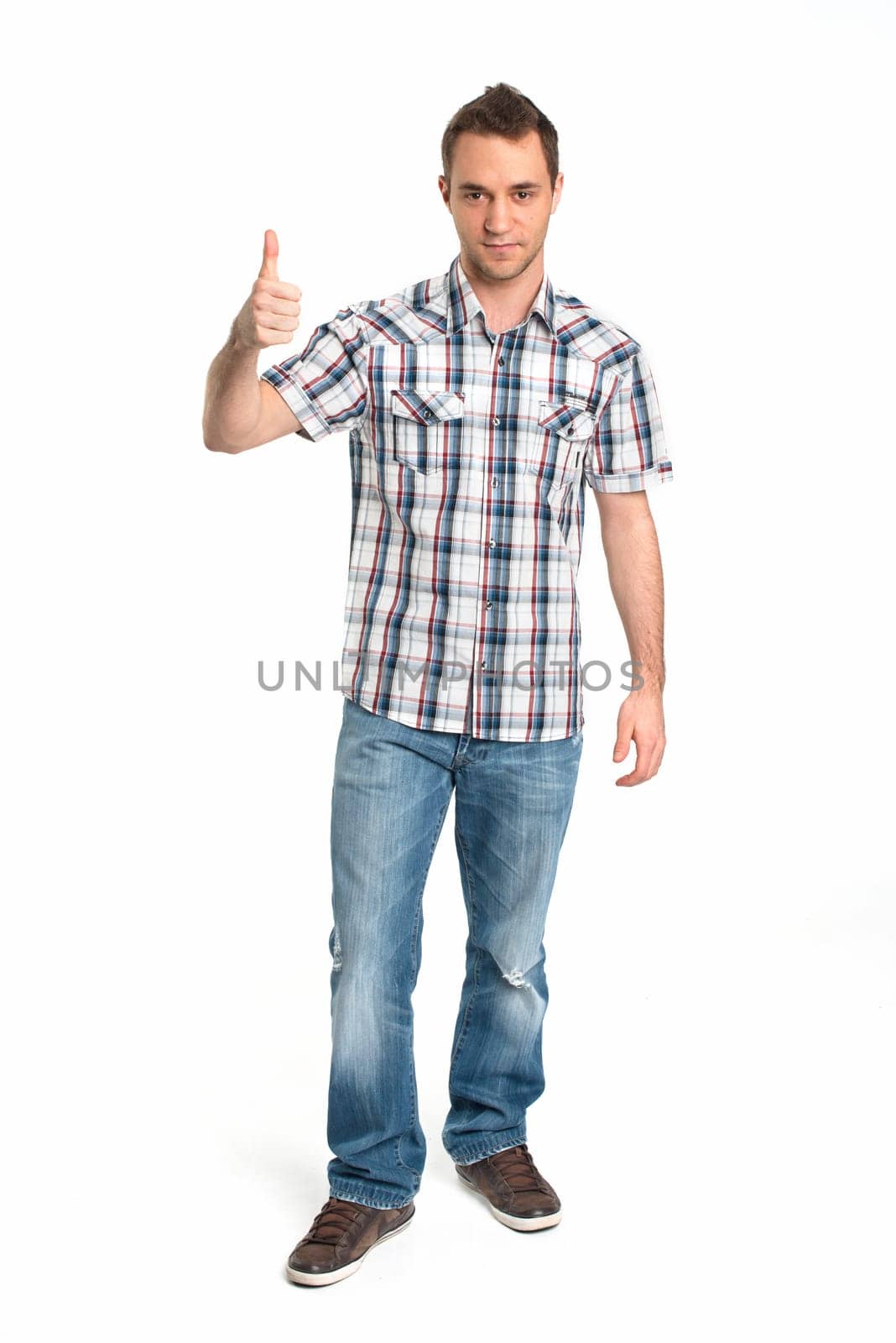 Young man in plaid shirt shows thumbs up