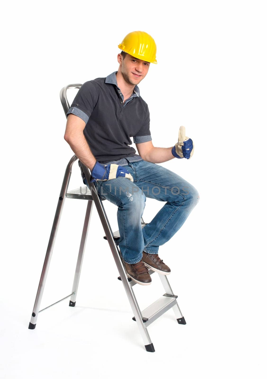 Young man with construction helmet and step ladder