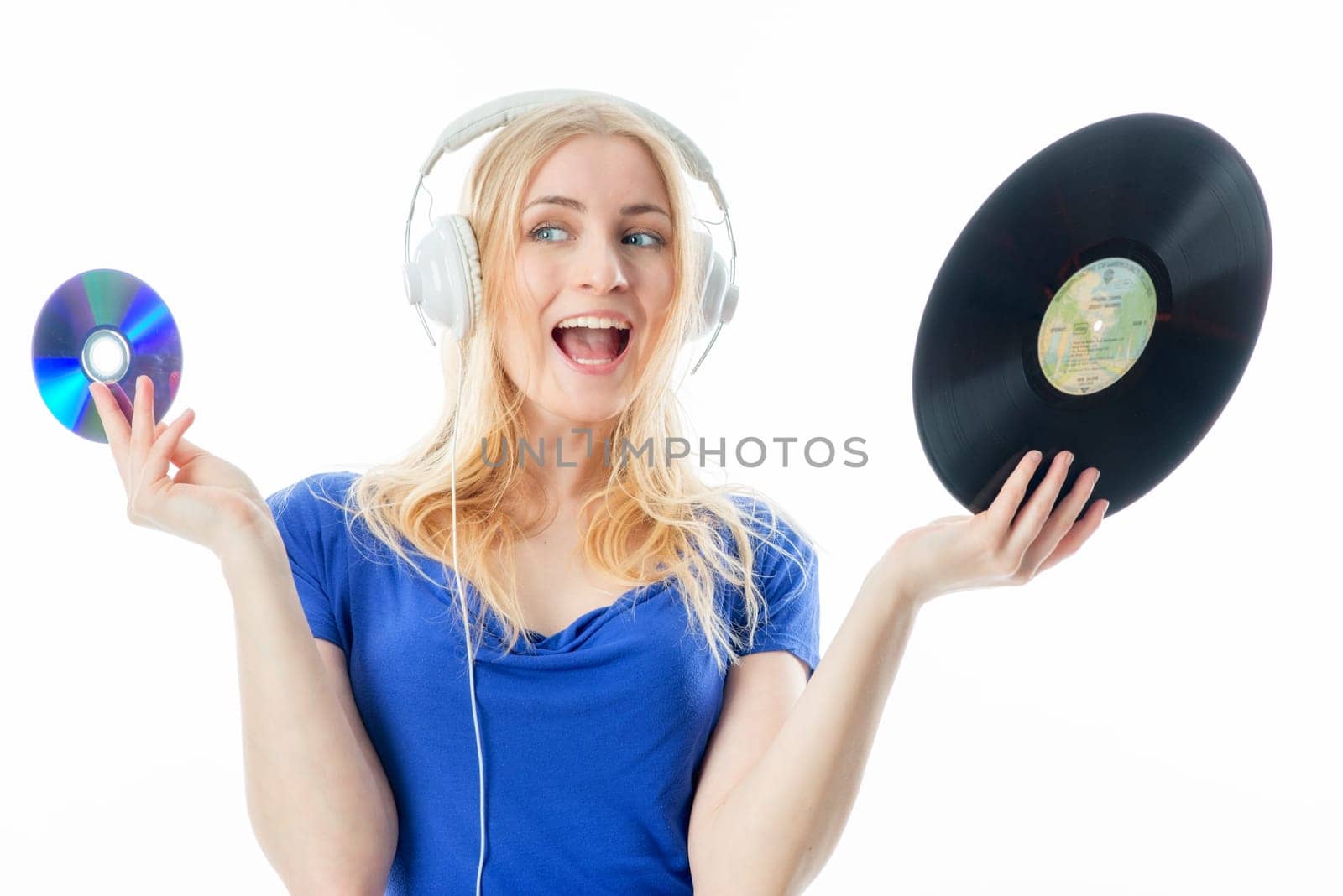 Blonde girl with headphones holds a record and a CD