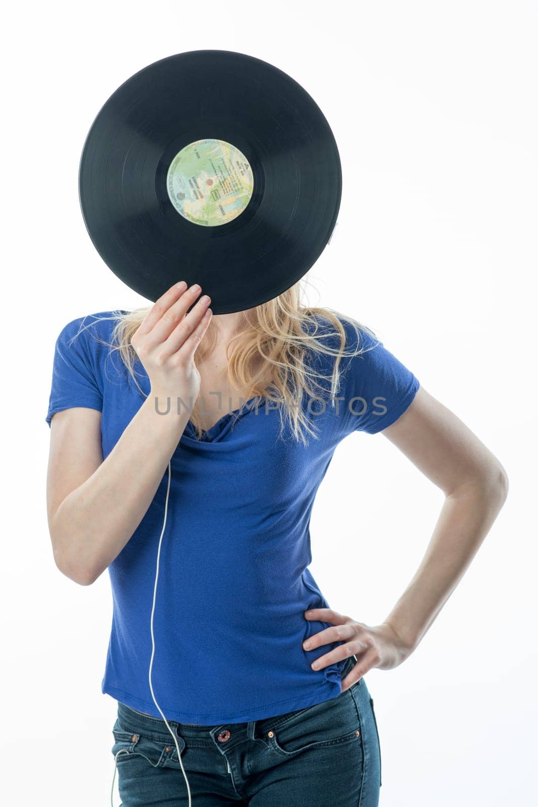 Blonde girl hides behind a record