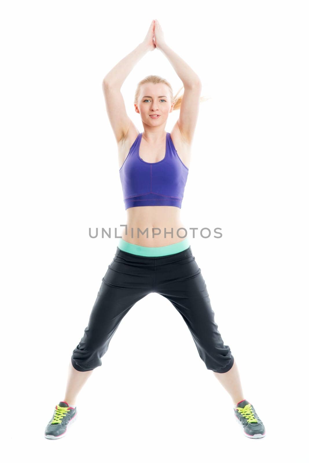 Blonde girl does fitness exercises