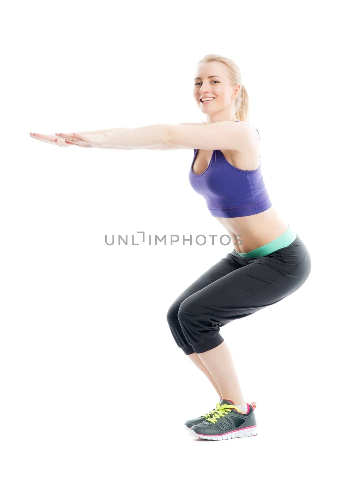 Blonde athlete does fitness exercises