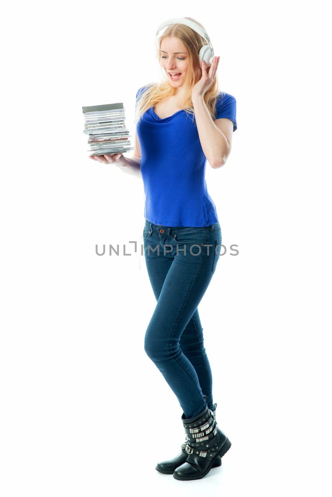 Blonde girl with headphones holds a Cd stack