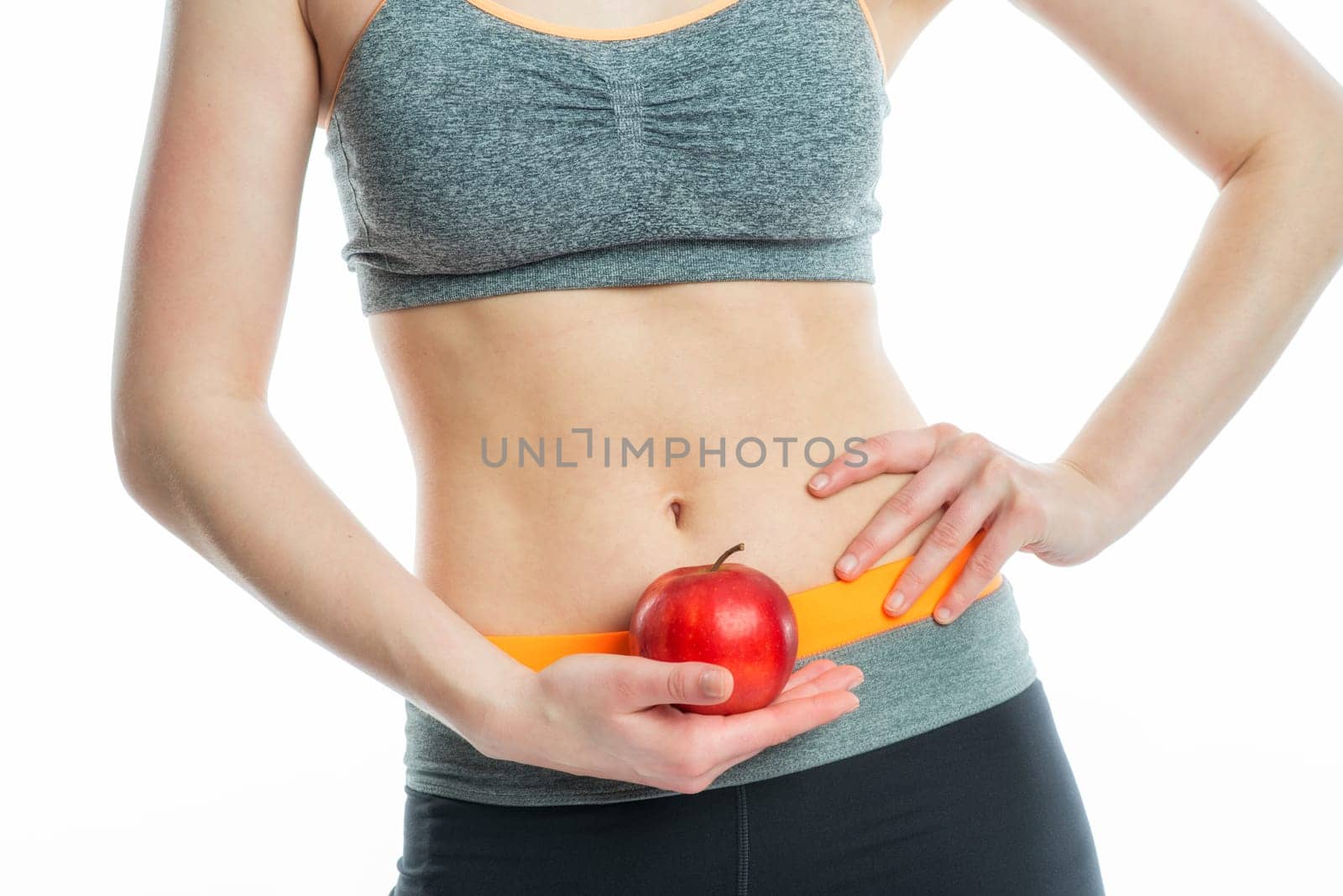 Blonde sportswoman with drink and apple