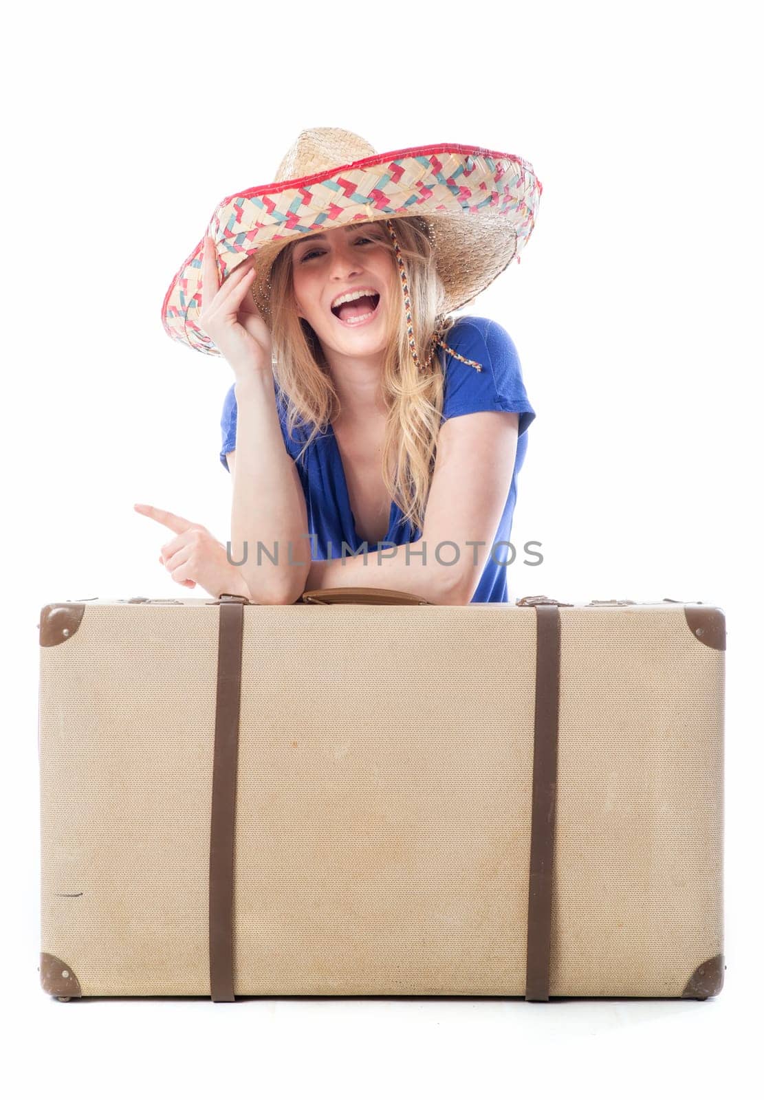 Blonde girl sits behind a suitcase
