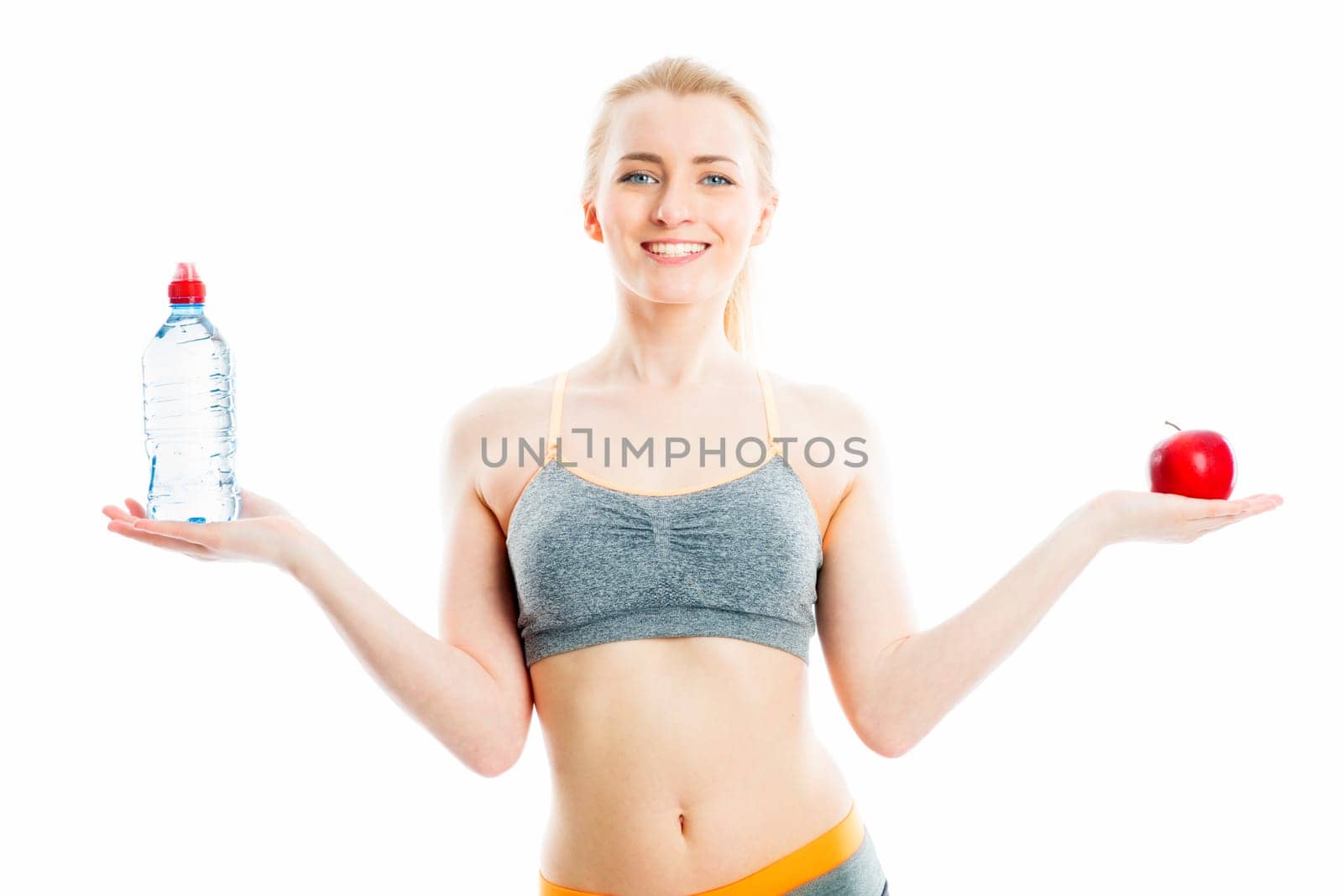 Blonde sportswoman with drink and fruit