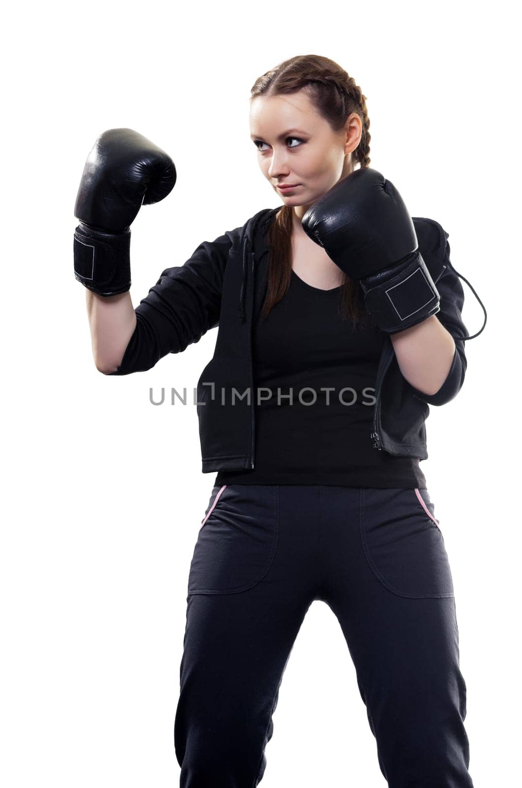 Young serious woman in boxing gloves on a white background