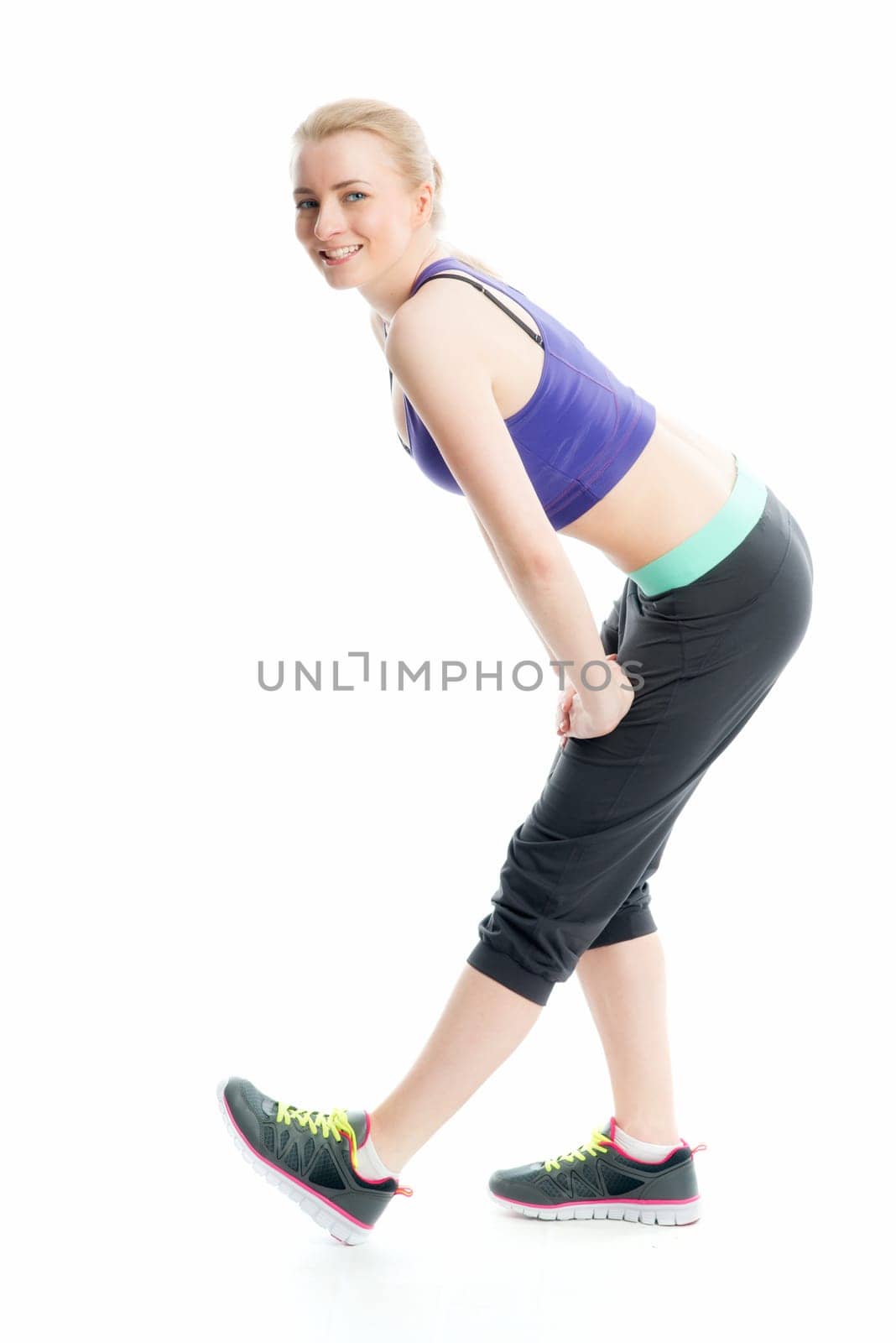 Blonde athlete does fitness exercises